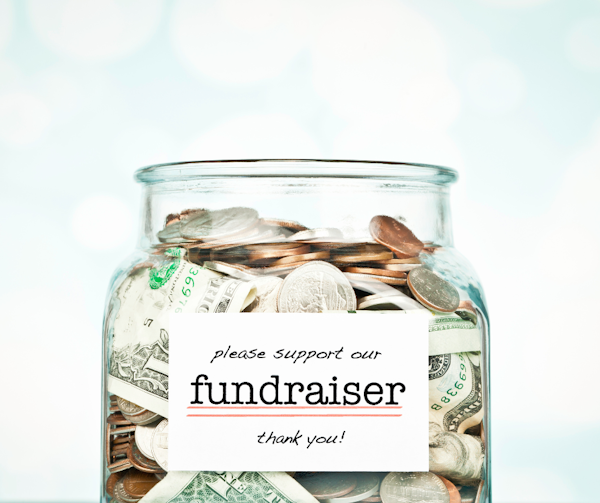 Jar containing cash labeled “Fundraiser”