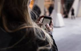 Person looking up how to get help on cell phone